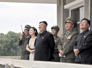 North Korean leader Kim Jong-un (3rd L) and his wife Ri Sol-ju (2nd L) look on during a visit to Unit 1017 of the Korean People's Army (KPA) Air and Anti-Air Force, honoured with the title of O Jung Hup-led 7th Regiment, in this undated picture released by North Korea's Korean Central News Agency (KCNA) on June 21, 2013. REUTERS/KCNA (NORTH KOREA - Tags: POLITICS MILITARY TRANSPORT) ATTENTION EDITORS - THIS PICTURE WAS PROVIDED BY A THIRD PARTY. REUTERS IS UNABLE TO INDEPENDENTLY VERIFY THE AUTHENTICITY, CONTENT, LOCATION OR DATE OF THIS IMAGE. FOR EDITORIAL USE ONLY. NOT FOR SALE FOR MARKETING OR ADVERTISING CAMPAIGNS. NO THIRD PARTY SALES. NOT FOR USE BY REUTERS THIRD PARTY DISTRIBUTORS. THIS PICTURE IS DISTRIBUTED EXACTLY AS RECEIVED BY REUTERS, AS A SERVICE TO CLIENTS - RTX10VI8